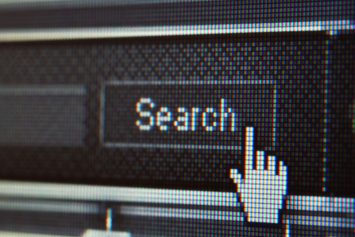 Extreme Closeup of Mouse Cursor over Search Button Search in B2B e-commerce, illustrative picture
